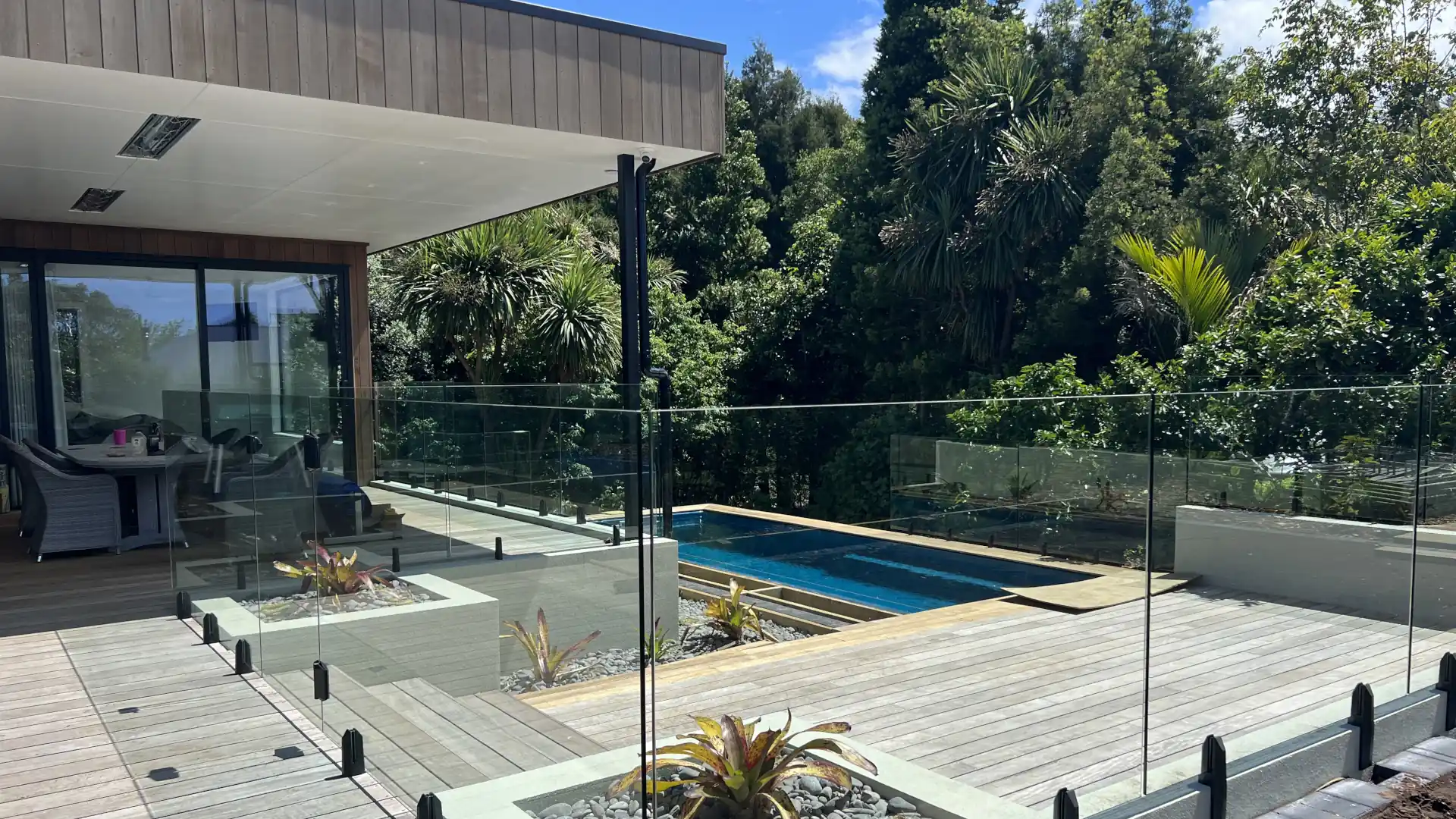 Pool fencing regulations NZ – compliant deck pool with glass fencing